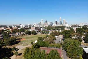 skyline of charlotte nc with blue sky and trees