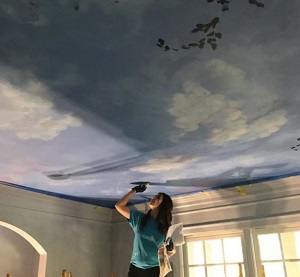 Doreen painting a ceiling